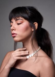 editorial photography of female model wearing necklace