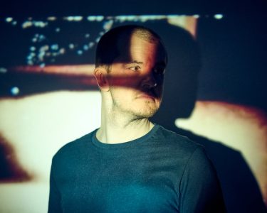 abstract portrait of DJ using film projector