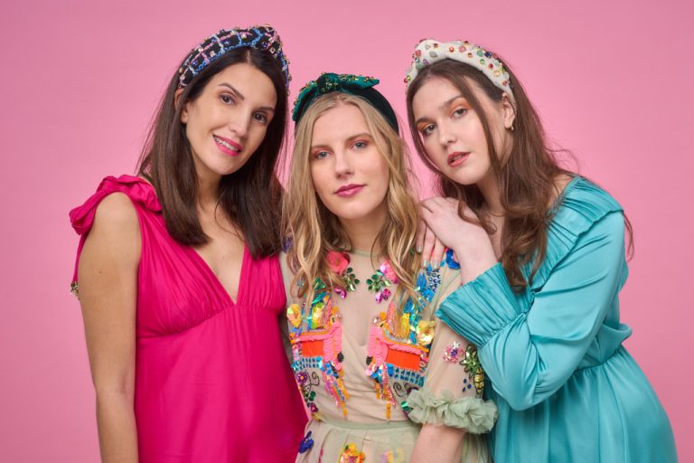 three female models with designer headbands