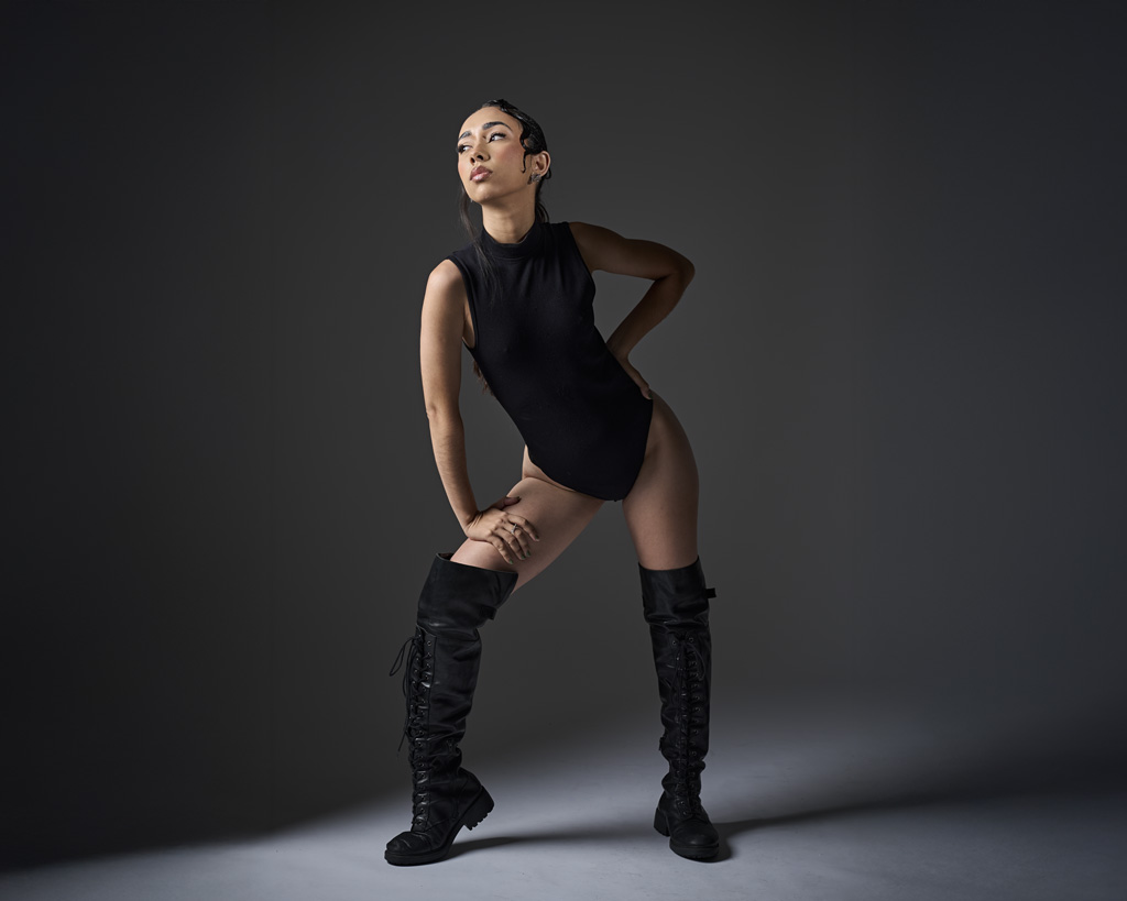 fashion portrait of model in high leather boots and body suit