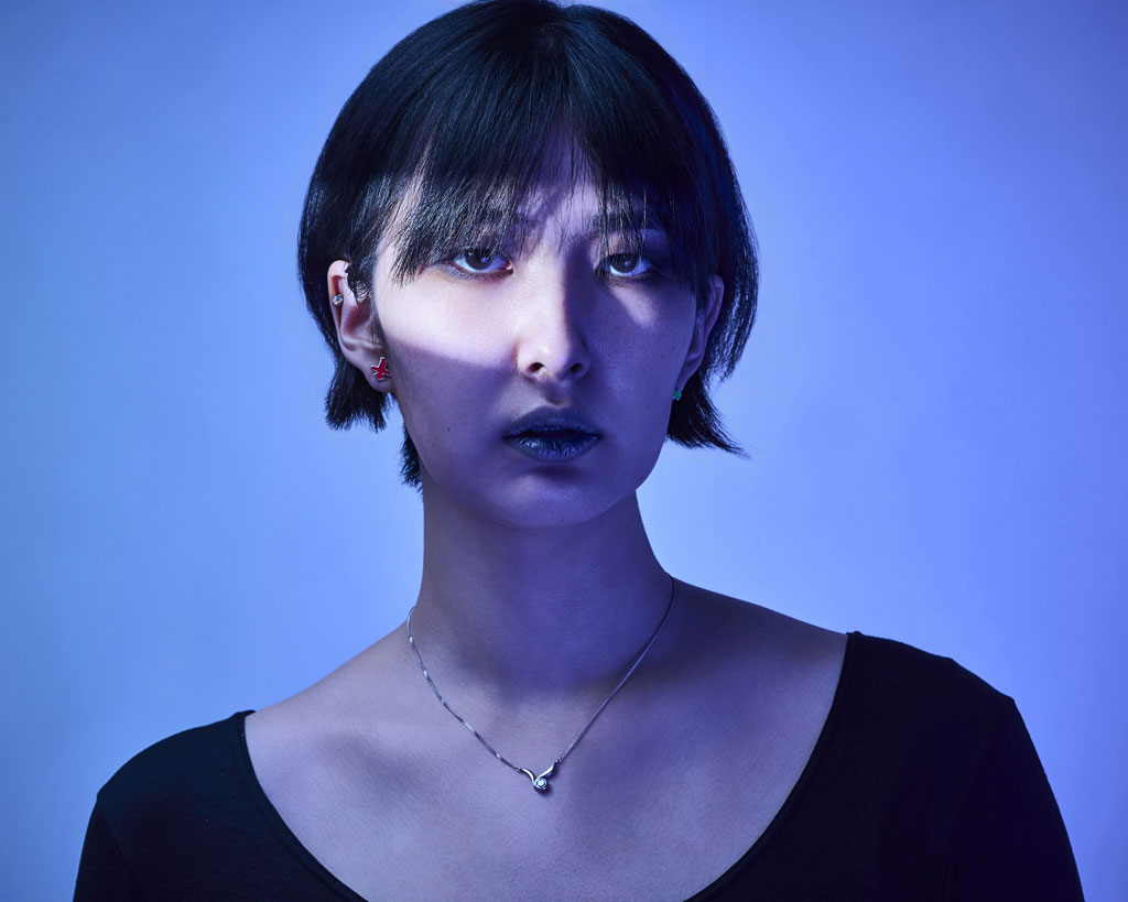 Portrait of Japanese female model with dramatic slice of light across her face