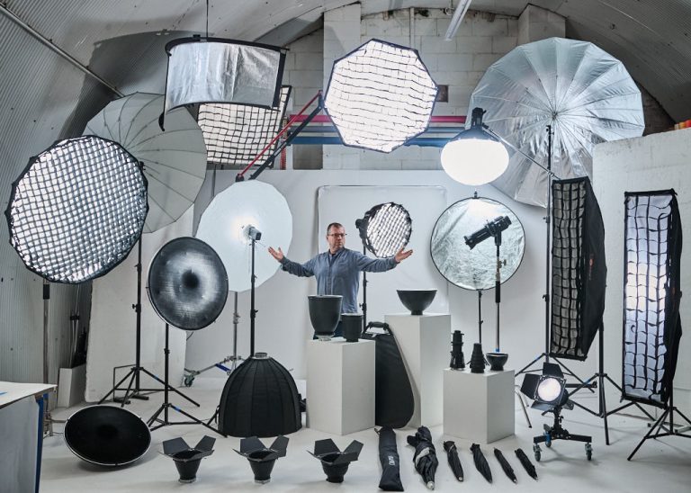 portrait of Robbie Ewing the owner of arch photo stduio with all his lighting equipment